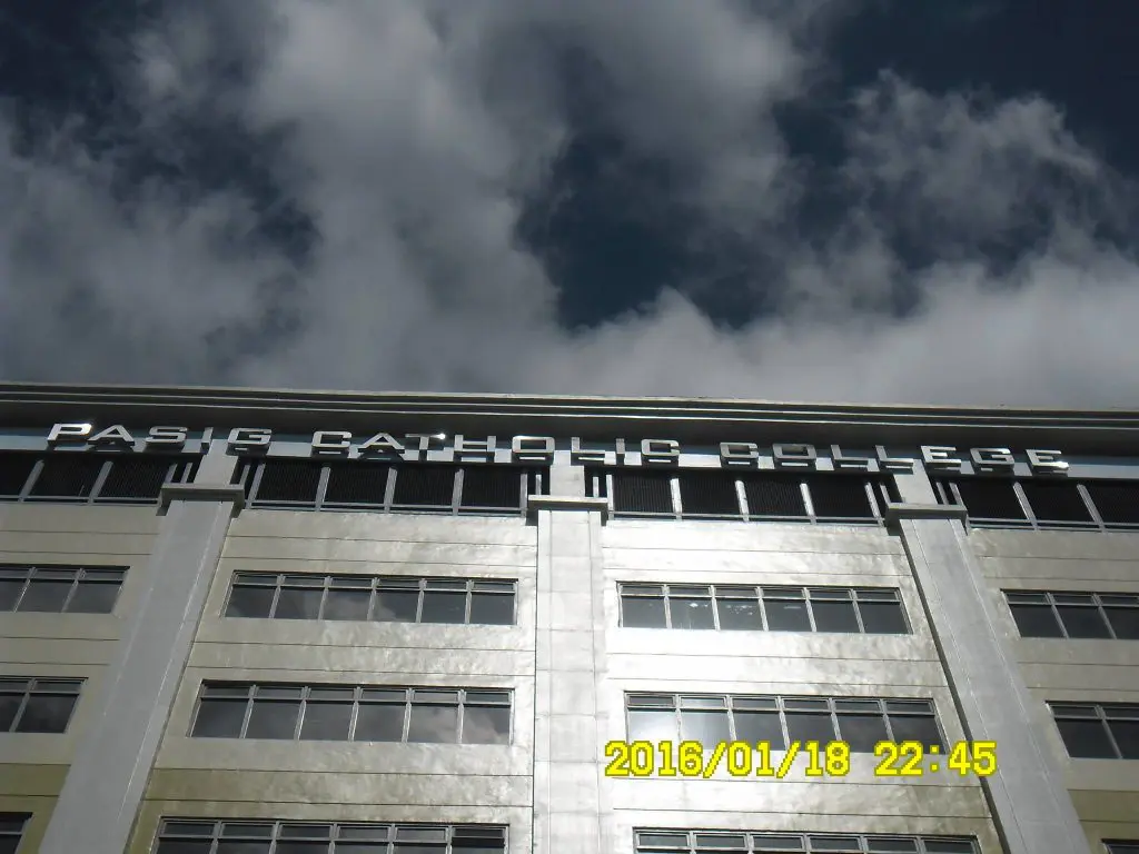 LED signage for Pasig Catholic College facade in Pasig City, seen from below; date and time visible. by M&G Global Ads.