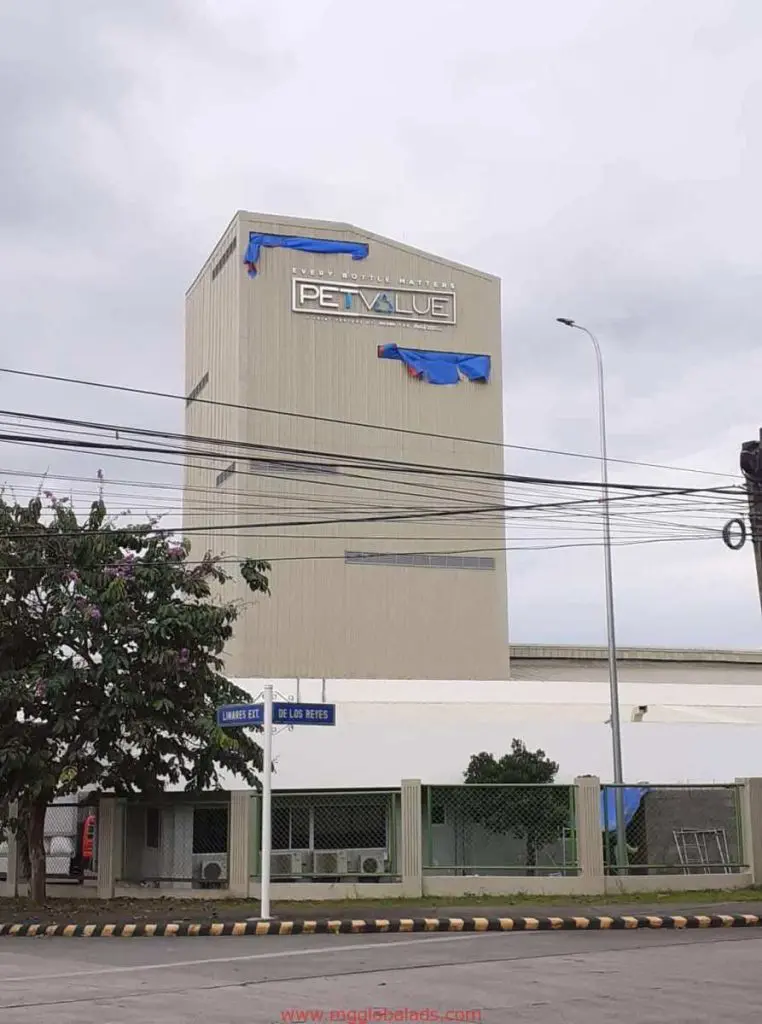 PETVALUE storefront signage installation with partially covered sign on beige building in Ortigas by M&G Global Ads.