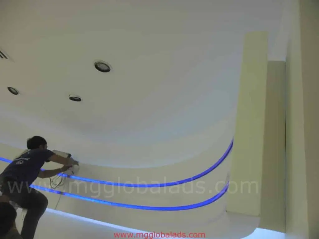 Indoor LED strip ceiling signage installation in an office in Makati, with modern lighting by M&G Global Ads.