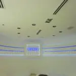 Illuminated building signage for RIMOWA on a modern white wall in Makati with blue accents, by M&G Global Ads.