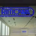 Illuminated acrylic RIMOWA signage at store entrance in Makati with glass reflections, by M&G Global Ads.