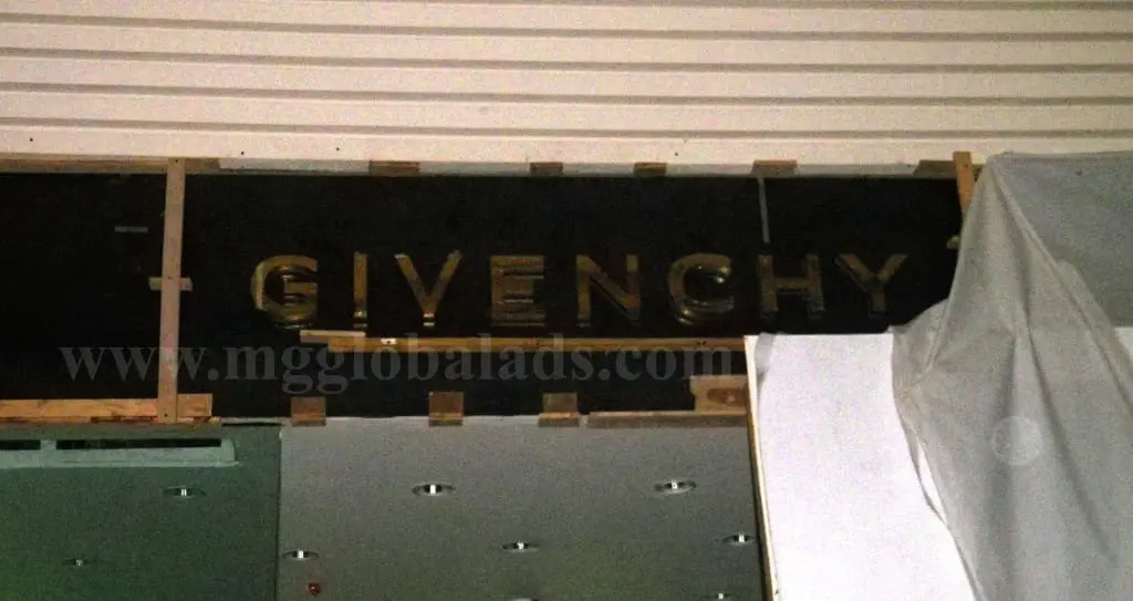 Acrylic store signage for GIVENCHY in Mandaluyong, partially covered and under renovation, by M&G Global Ads.