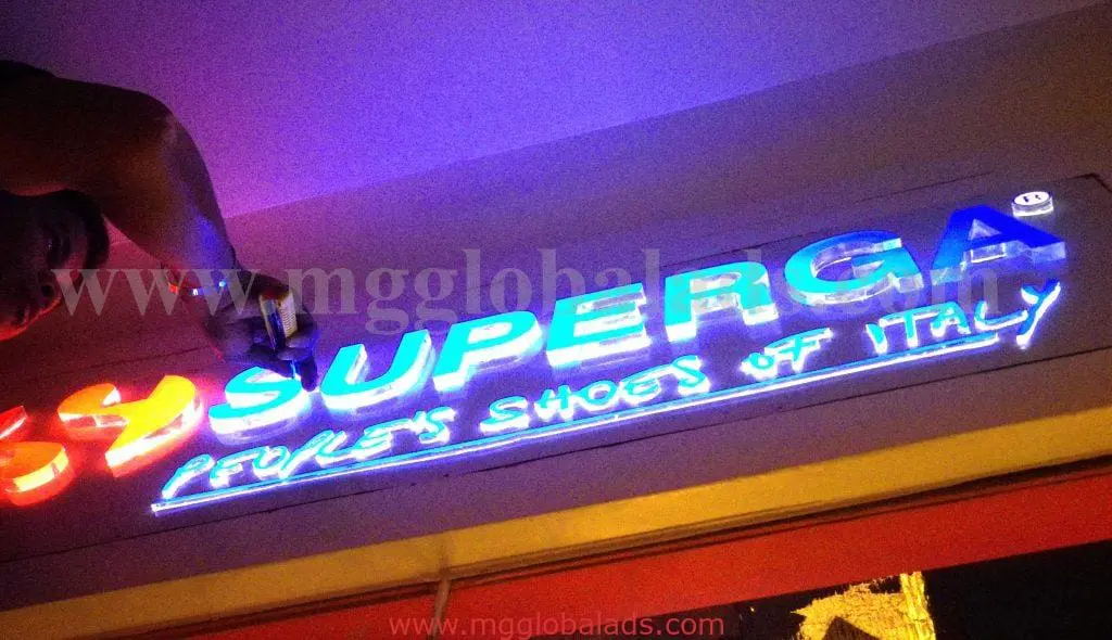 Neon signage for SUPERGA PEOPLES SHOES OF ITALY above shop entrance in Makati, in blue, white, red by M&G Global Ads.