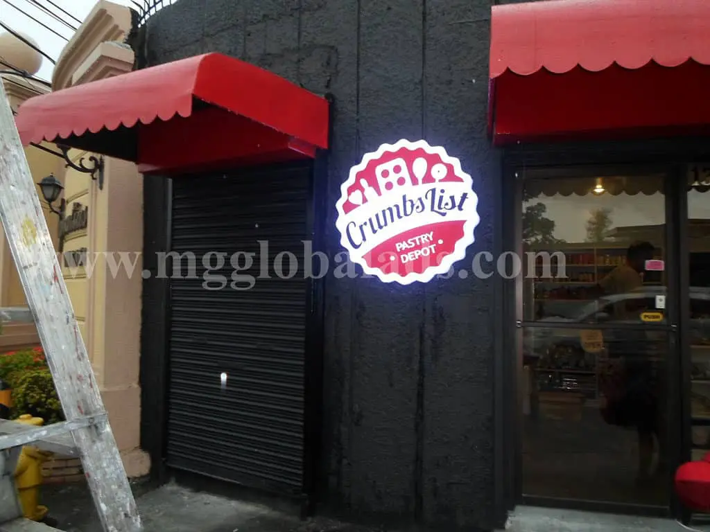 LED signage for Crumbs List Pastry Depot in Mandaluyong, mounted on a black wall with red awnings by M&G Global Ads.