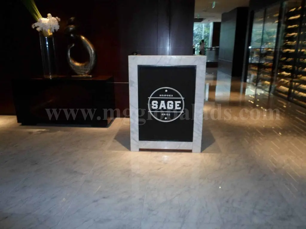 Marble lobby signage for SAGE in Makati, crafted by a signage maker Philippines, shiny floor reflection, by M&G Global Ads.