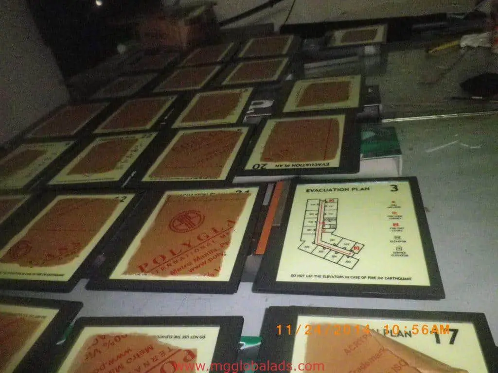 Acrylic evacuation plan signage with floor maps, arranged on a table in Mandaluyong, by M&G Global Ads.