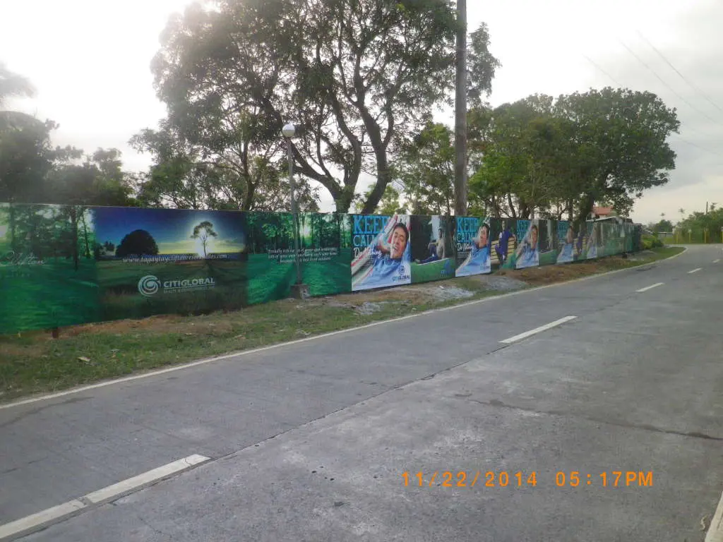 Billboard fence signage for CITIGLOBAL in Makati with trees, open fields, KEEP CALM slogan by M&G Global Ads.