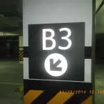 LED indoor parking signage B3 with down-left arrow at Quezon City parking garage, timestamped. By M&G Global Ads.