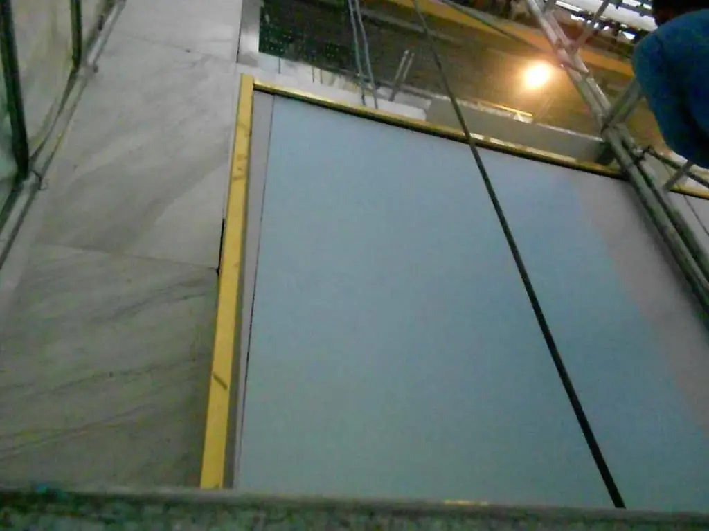 Indoor LED signage installation for client in Quezon City, blue and yellow panel lifted during construction by M&G Global Ads.