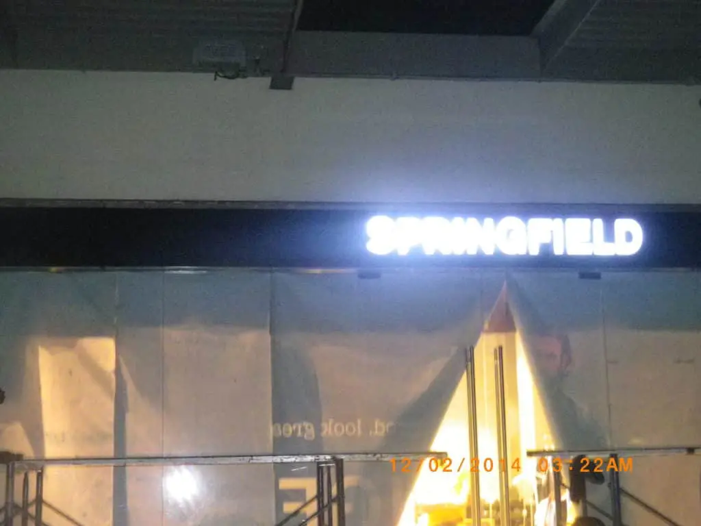 SPRINGFIELD LED signage above glass doors in Quezon City, installed by M&G Global Ads. Partial plastic sheet cover visible.