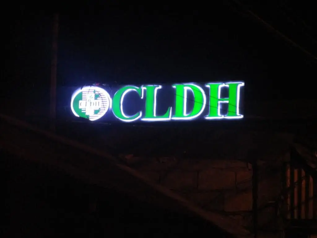 Outdoor building signage for CLDH with green and white logo in Makati by M&G Global Ads, above windows with metal bars.
