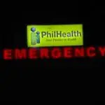 Lit acrylic emergency signage for PhilHealth with logo and red arrow in Quezon City healthcare facility by M&G Global Ads.
