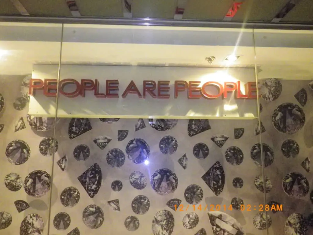 Acrylic signage PEOPLE ARE PEOPLE on black and white diamond wall, Quezon City, by M&G Global Ads.