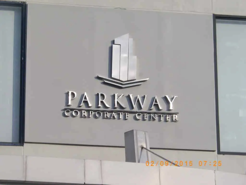 Silver acrylic signage for Parkway Corporate Center, skyscraper logo, gray facade in Ortigas by M&G Global Ads.