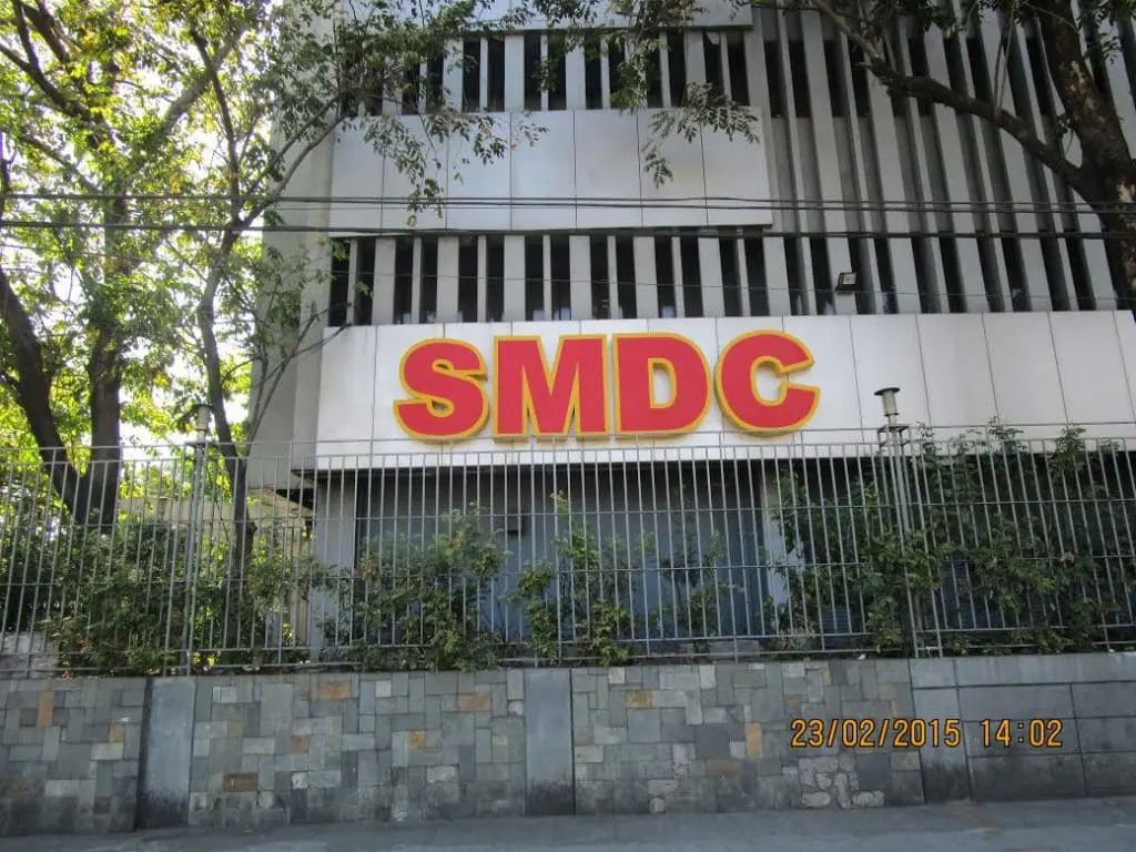 SMDC outdoor building signage in bold yellow and red, Quezon City location, by M&G Global Ads.