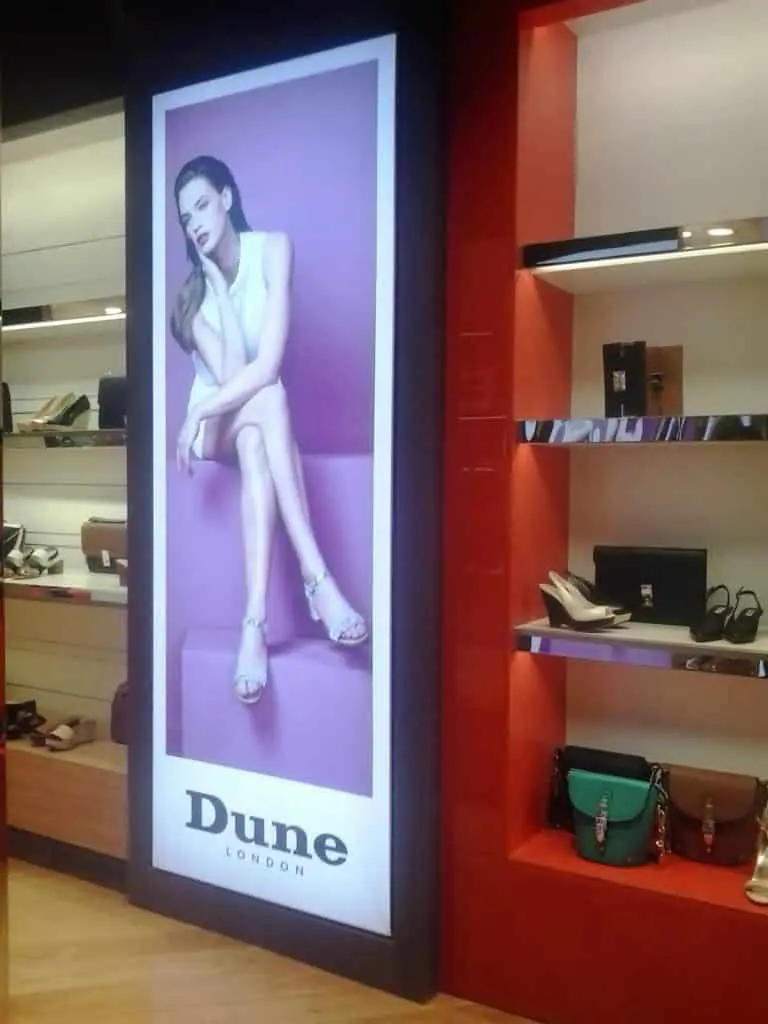 Vertical poster signage for Dune London with stylish indoor display in Makati store by M&G Global Ads.
