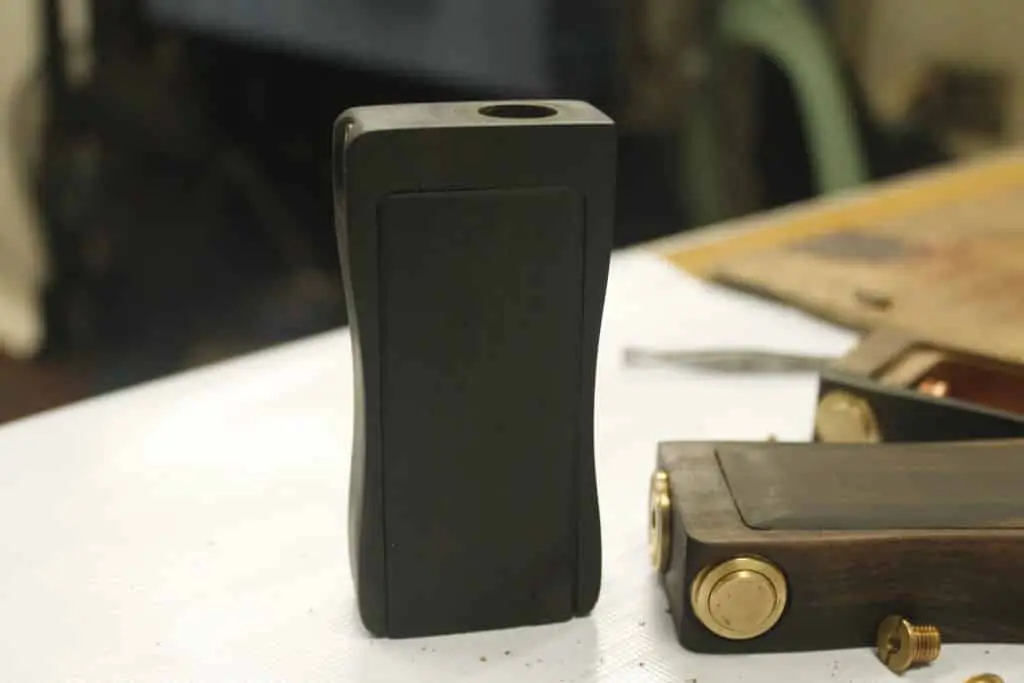 Acrylic signage for vape shop in Makati with handmade wooden box mods and tools on white table by M&G Global Ads.