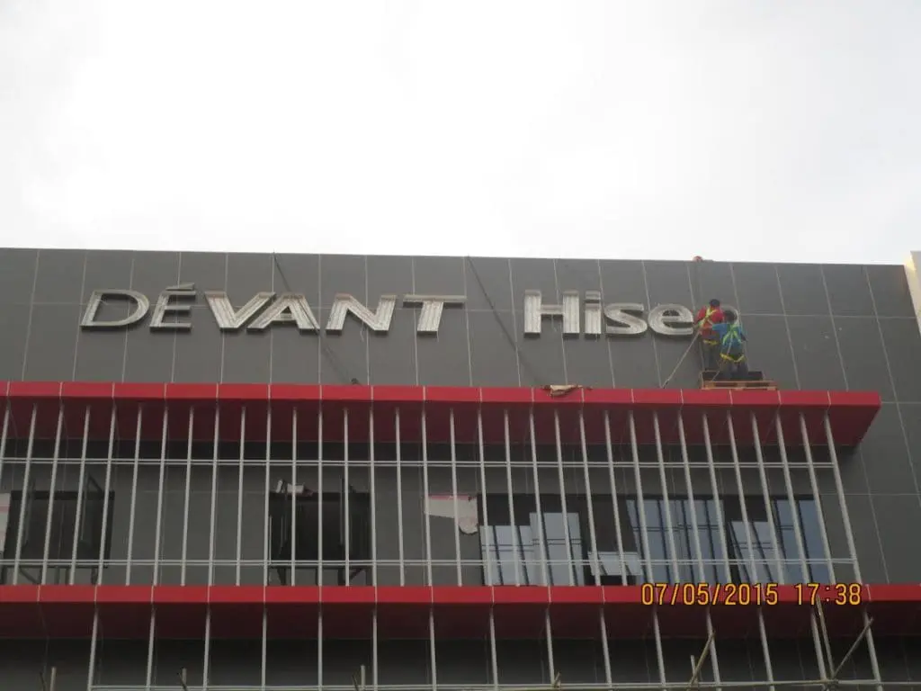 DEVANT Hise outdoor building signage installation in Makati, grey facade with red and silver accents by M&G Global Ads.