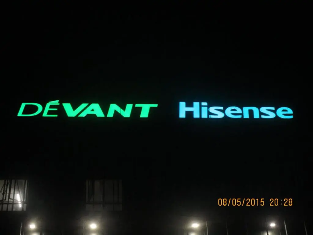 LED building signage for DÉVANT and Hisense in blue and green, night view, Makati location, by M&G Global Ads.
