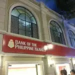 Building signage for Bank of the Philippine Islands with red logo in Makati, large arched windows. By M&G Global Ads.