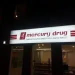 Mercury Drug illuminated building signage in Ortigas at night, red logo, tagline displayed above entrance by M&G Global Ads.