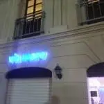 Neon blue LED signage for Via Mare restaurant above a closed white shutter at night in Makati, by M&G Global Ads.