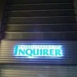 Building signage installation for ABS theater, featuring green adhesive sheet application in Quezon City by M&G Global Ads.