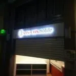 ABS-CBN Mobile illuminated acrylic signage, store with metal shutter in Ortigas, Metro Manila. By M&G Global Ads.