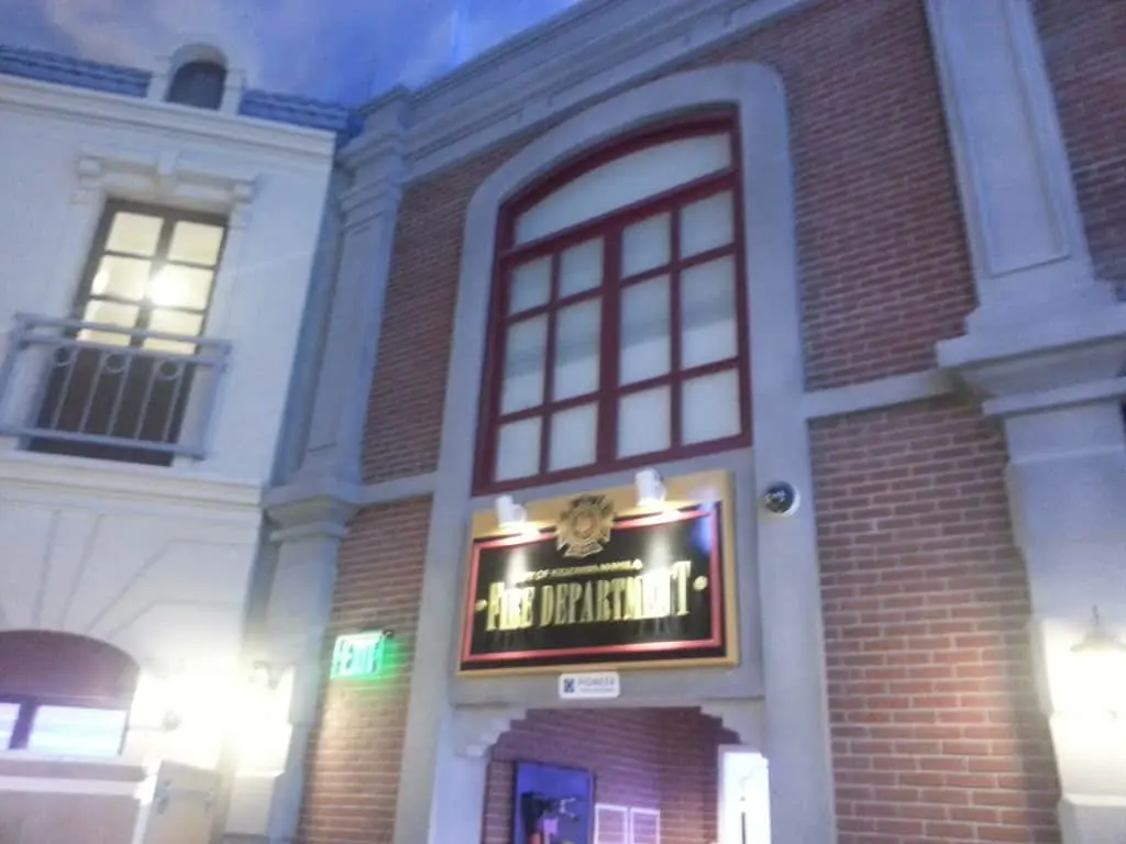Fire Department outdoor signage on red brick facade with arched window in Makati, illuminated exit sign by M&G Global Ads.