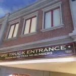 Building facade with FIRE TRUCK ENTRANCE Pasukan ng Trak ng Bumbero 1932 signage in Quezon City by M&G Global Ads.