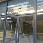 LED EXIT signage indoor installation above secured glass double doors in Mandaluyong by M&G Global Ads.