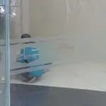 Indoor glass wall signage for Cherry client installation in Quezon City, worker in blue shirt cleaning, by M&G Global Ads.