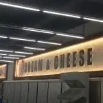 Backlit metallic CREAM & CHEESE signage in Quezon City, with partial sign and fluorescent ceiling by M&G Global Ads.