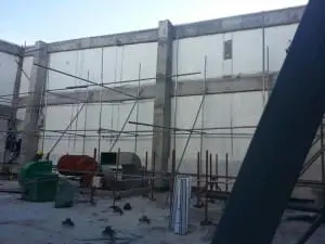 Acrylic signage on a construction site in Makati with scaffolding, building materials, and equipment by M&G Global Ads.