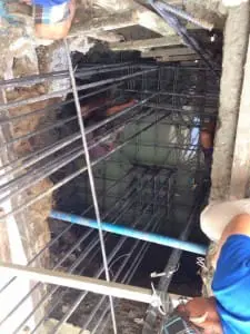 Outdoor billboard signage with blank display and No Parking sign in Mandaluyong, blue sky, shadows—by M&G Global Ads.