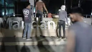 Billboard installation crew works at night with equipment and cables, trees and lights in Mandaluyong by M&G Global Ads.