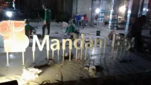Building signage installation for Mandan Bay, metallic sign, at night in BGC, by M&G Global Ads.