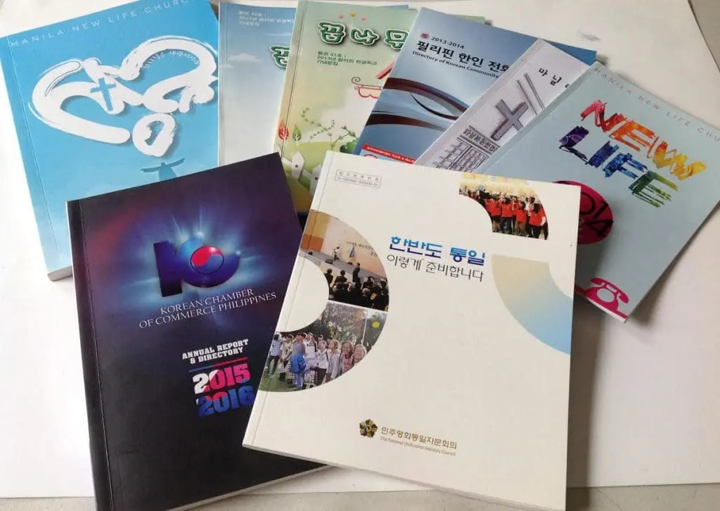 Indoor signage for Korean Chamber of Commerce Philippines with books on white surface, Makati. By M&G Global Ads.