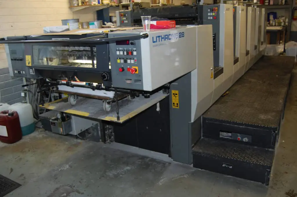 Acrylic and building signage printing press at a Quezon City shop, Lithrone 28 machine, supplies visible by M&G Global Ads.