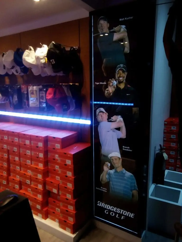 Bridgestone Golf LED signage display with orange shoe boxes and golf hats in Makati store by M&G Global Ads.