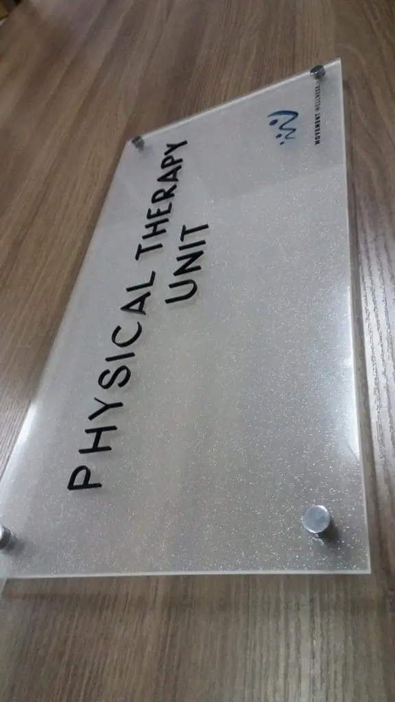 Indoor metallic signage for Physical Therapy Unit, Quezon City, with black text and blue logo on wood by M&G Global Ads.