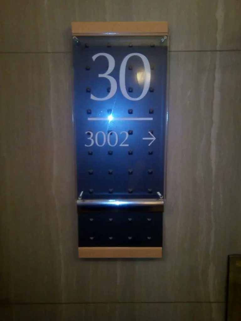 Acrylic room signage with raised dots and wood accents, 30/3002 directional sign in Makati by M&G Global Ads.