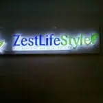 Indoor metallic signage for ZestLifeStyle with blue-green leaf logo in Makati, modern design by M&G Global Ads.