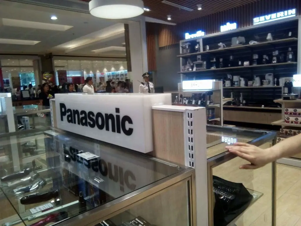 Panasonic acrylic signage at retail store with display counter, glass shelves in Makati by M&G Global Ads.