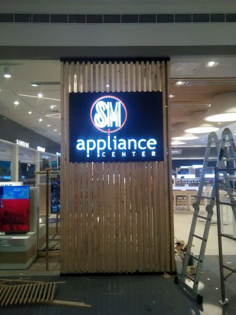 Illuminated metallic SM Appliance Center signage at store display in Makati, installation setup by M&G Global Ads.