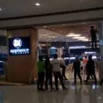 SM Appliance Center indoor signage installation in Quezon City mall entrance with workers and appliances, by M&G Global Ads.