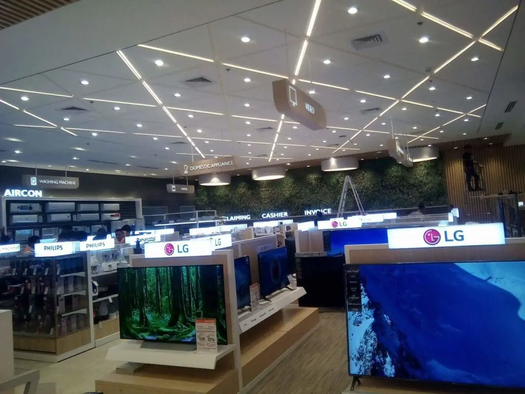 LED signage for Philips, Sony, and LG in an electronics store in Makati with a plant wall. By M&G Global Ads.