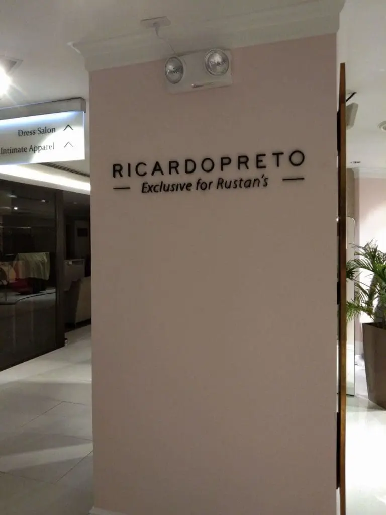 Black acrylic RICARDOPRETO signage for Rustans at retail store with plants and signs, Makati, by M&G Global Ads.