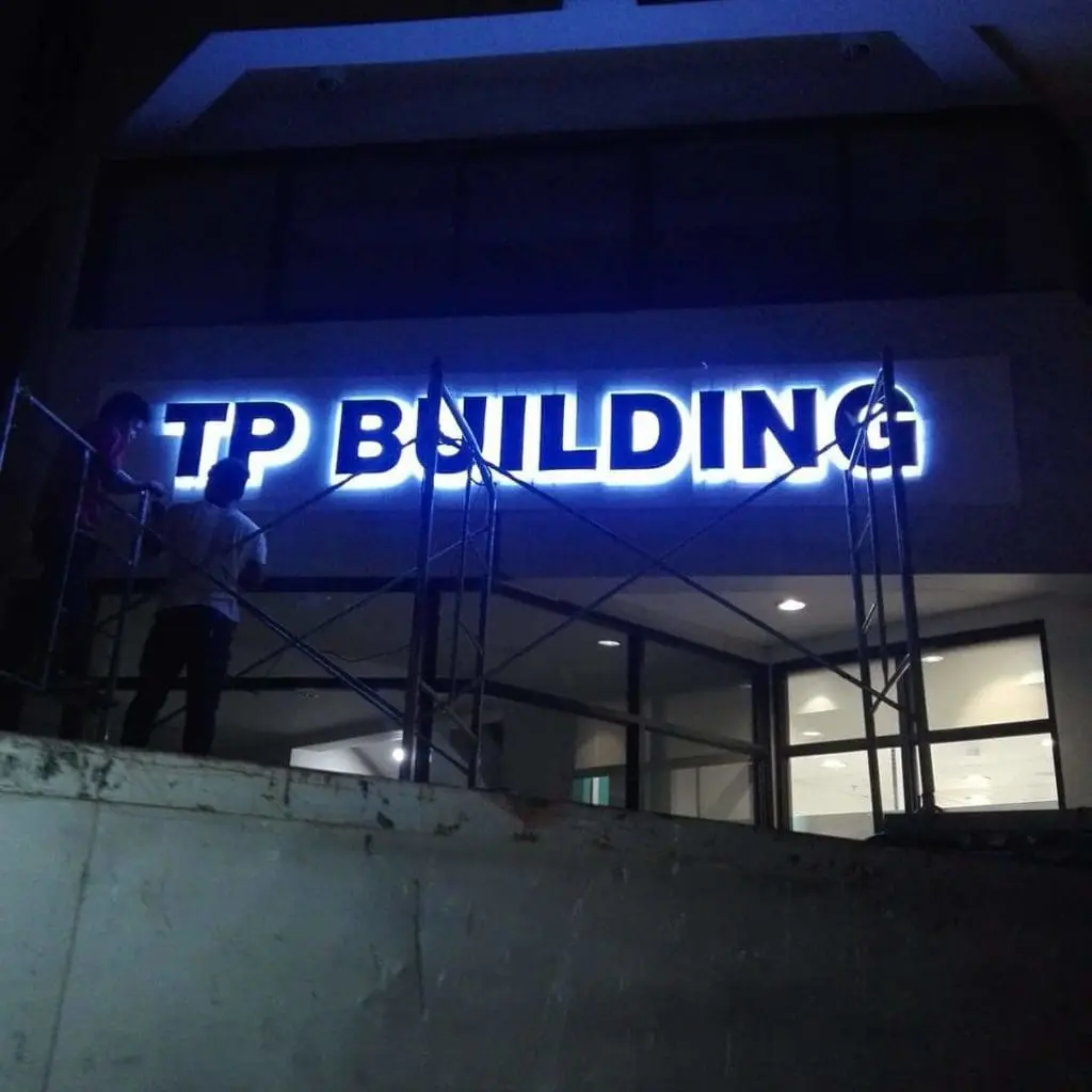 LED business signage for TP Building installed at night in Quezon City, blue-lit letters, by M&G Global Ads.