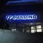 LED business signage for TP Building installed at night in Quezon City, blue-lit letters, by M&G Global Ads.